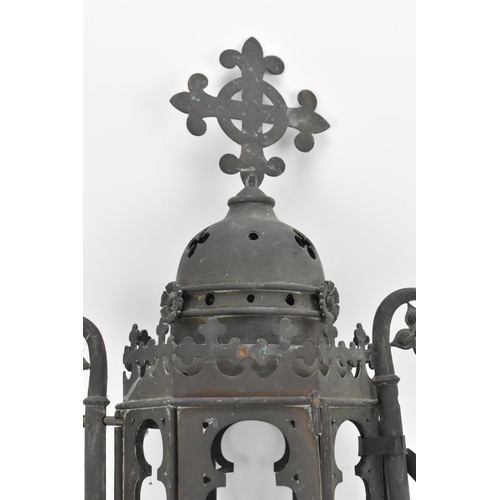 387 - A Gothic Revival wrought iron lantern, of hexagonal form with arched openings, surmounted with fleur... 