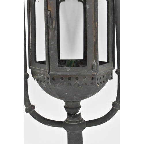 387 - A Gothic Revival wrought iron lantern, of hexagonal form with arched openings, surmounted with fleur... 