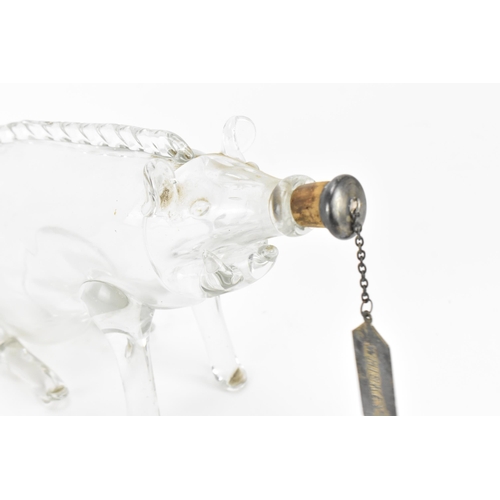 389 - An Edwardian hand blown clear glass novelty decanter, modelled as a seated pig, with silver whisky l... 