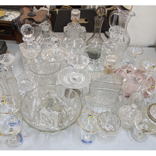 110 - A mixed lot of glassware to include decanters, a pair of glass candlesticks, vases, a set of Babycha... 