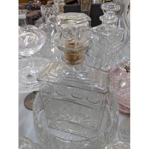 110 - A mixed lot of glassware to include decanters, a pair of glass candlesticks, vases, a set of Babycha... 