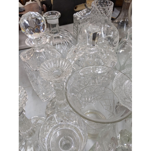 110 - A mixed lot of glassware to include decanters, a pair of glass candlesticks, vases, a set of Babycha... 