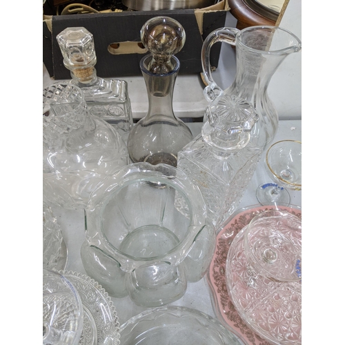 110 - A mixed lot of glassware to include decanters, a pair of glass candlesticks, vases, a set of Babycha... 