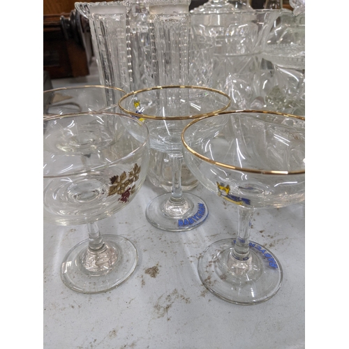 110 - A mixed lot of glassware to include decanters, a pair of glass candlesticks, vases, a set of Babycha... 