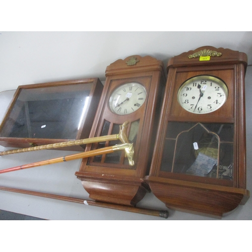 111 - Two 8 day wall hanging clocks together with a display table top cabinet and three walking sticks, on... 