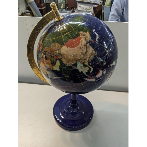 126 - A modern table top globe inset with semi precious stones, made of lapis, 63cm tall 
Location: RAB