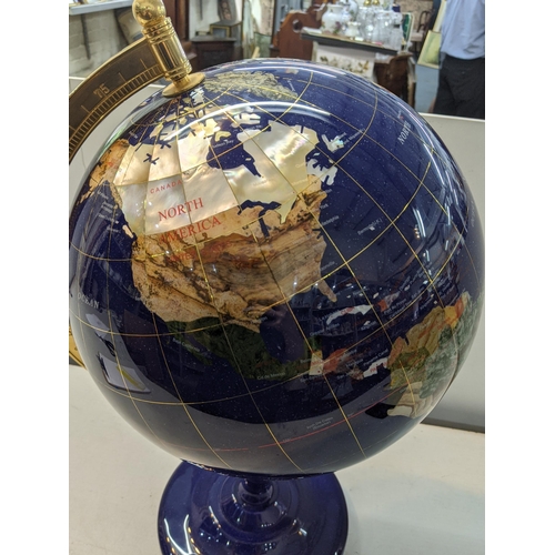 126 - A modern table top globe inset with semi precious stones, made of lapis, 63cm tall 
Location: RAB