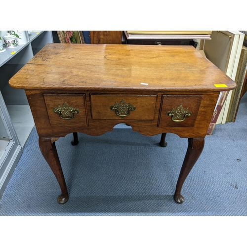 160 - A Georgian oak lowboy having three drawers and on cabriole legs with pad feet 69.5cm h x 77.5cm w 
L... 