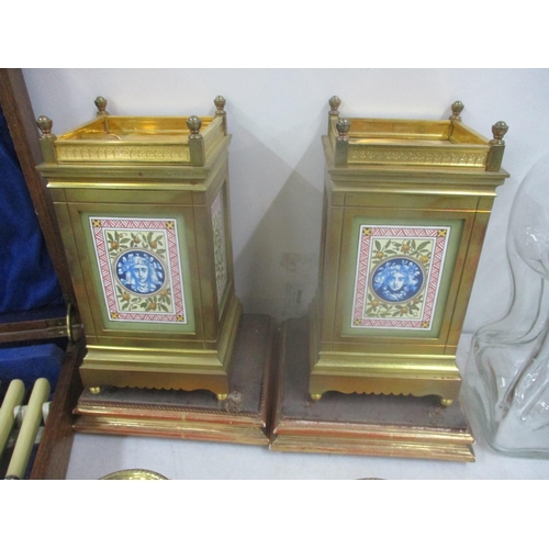 163 - A pair of Victorian garnitures inset with porcelain panels together with a pair of brass Adoms style... 