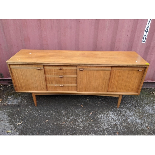 18 - A mid 20th century teak sideboard raised on turned tapering legs, 46cm h x 169cm w
Location: CON