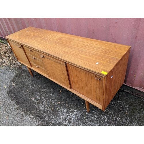 18 - A mid 20th century teak sideboard raised on turned tapering legs, 46cm h x 169cm w
Location: CON