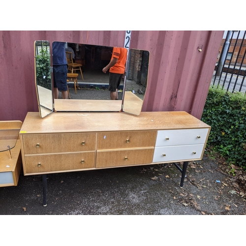 19 - A mid 20th century possibly G-Plan six drawer dressing table together with a similar headboard with ... 