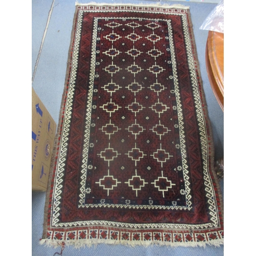 2 - An Iranian hand woven rug having red ground, geometric design and multi-guard boarders, 197cm x 106c... 