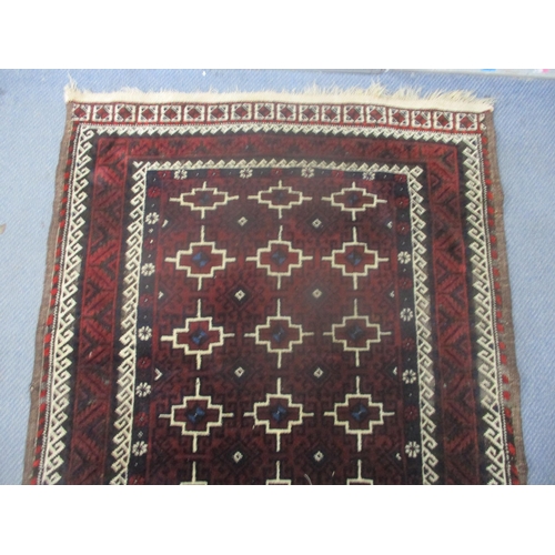 2 - An Iranian hand woven rug having red ground, geometric design and multi-guard boarders, 197cm x 106c... 