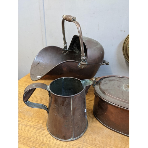 240 - A mixed lot of Victorian and later copper and brassware to include a large oval lidded casserole pot... 