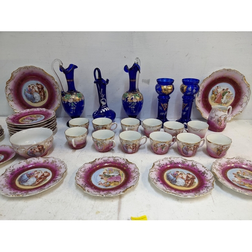 333 - A late 19th century French tea set decorated with figures in panels and a pair of blue glass vases a... 