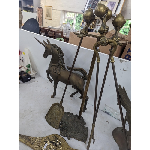 35 - A brass model of a Pegasus 40cm high, a similar model of a Unicorn, along with fireside implements a... 