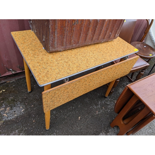 364 - A mixed lot of furniture to include a Formica kitchen table, retro teak fall flap table and other it... 