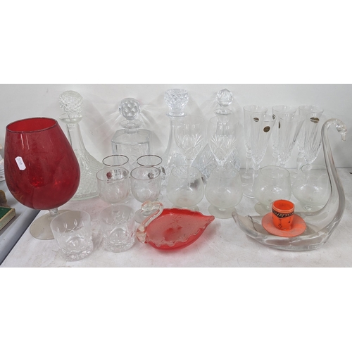 37 - A mixed collection of glassware to include cut crystal decanters and others, along with glass model ... 