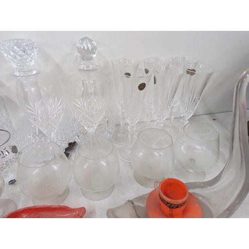 37 - A mixed collection of glassware to include cut crystal decanters and others, along with glass model ... 