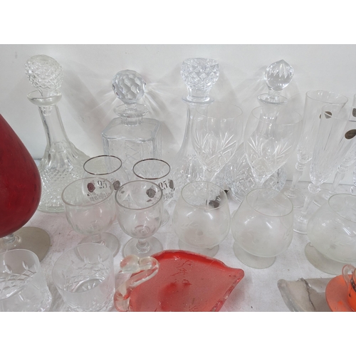 37 - A mixed collection of glassware to include cut crystal decanters and others, along with glass model ... 