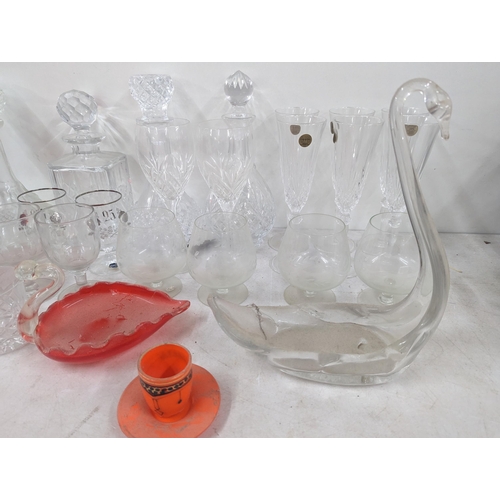 37 - A mixed collection of glassware to include cut crystal decanters and others, along with glass model ... 