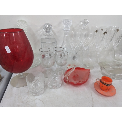 37 - A mixed collection of glassware to include cut crystal decanters and others, along with glass model ... 