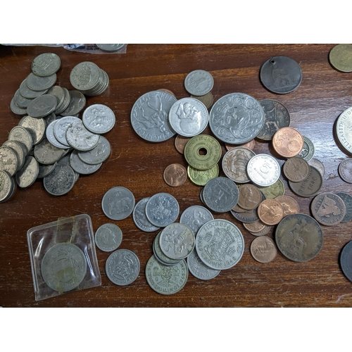 371 - A collection of British and foreign coinage and tokens to include George VI and III silver shillings... 