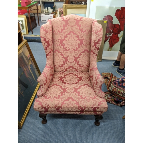 390 - A mid 20th century wingback armchair, on front mahogany cabriole legs, with floral upholstery
Locati... 