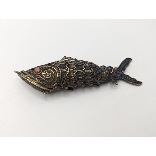 406 - A pillbox in the form of an articulated fish, stamped silver, approx 8cm
Location: CAB1