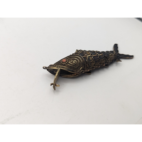 406 - A pillbox in the form of an articulated fish, stamped silver, approx 8cm
Location: CAB1