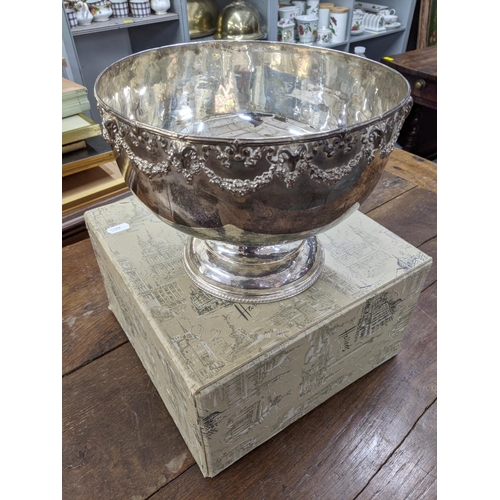 414 - A silver plated punch bowl having a rams head and floral design to the top in a Harrods box
Location... 