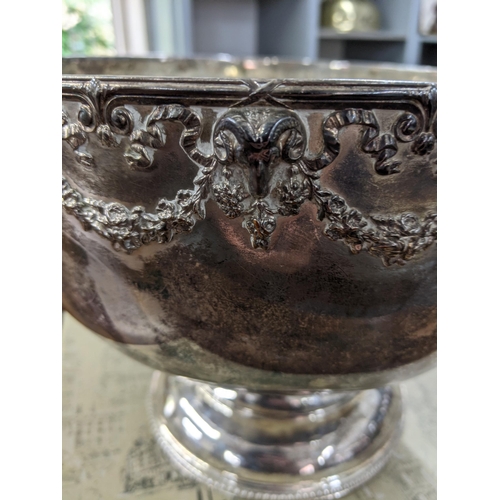 414 - A silver plated punch bowl having a rams head and floral design to the top in a Harrods box
Location... 