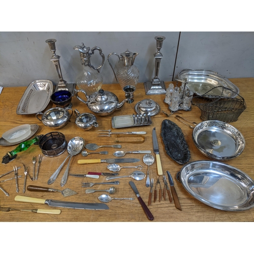 64 - A mixed lot of silver plate to include a pair of neo-classical style Edwardian candlesticks, two gla... 