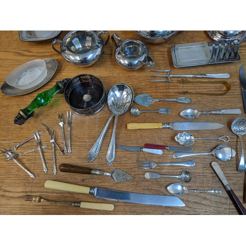 64 - A mixed lot of silver plate to include a pair of neo-classical style Edwardian candlesticks, two gla... 