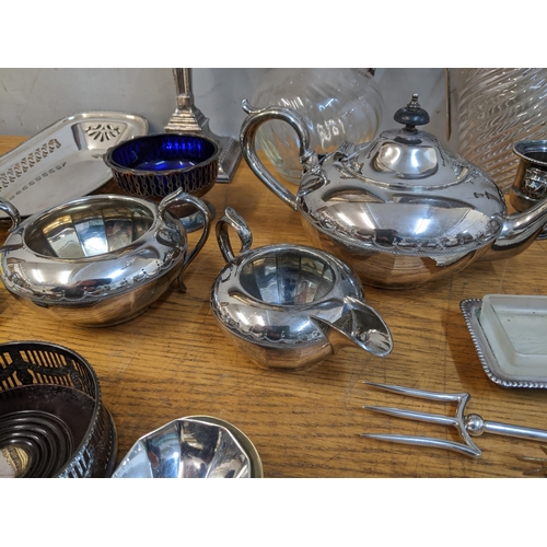 64 - A mixed lot of silver plate to include a pair of neo-classical style Edwardian candlesticks, two gla... 