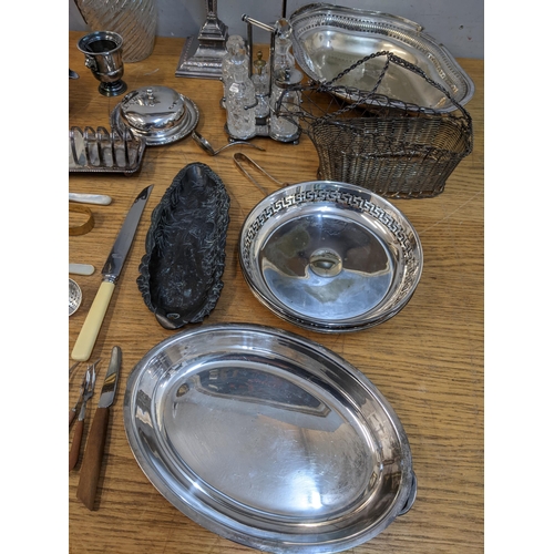 64 - A mixed lot of silver plate to include a pair of neo-classical style Edwardian candlesticks, two gla... 