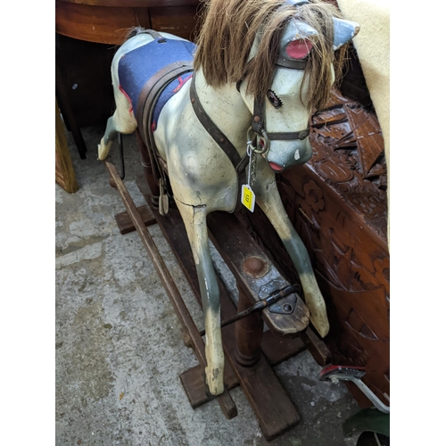 133 - Early 20th painted wooden rocking horse on wooden safety base as a dapple grey with leather bridle a... 