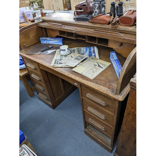 157 - A 1930s/40s oak roll top twin pedestal desk having a fitted interior above nine drawers 101cm h x 12... 