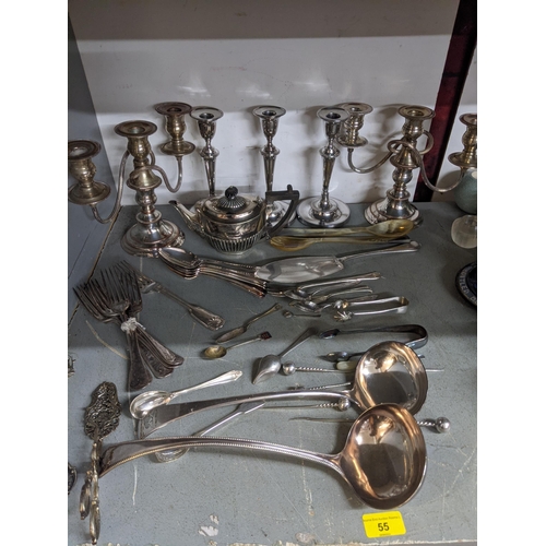 55 - A mixed lot of silver plated table wares to include a pair of Sheffield plated candelabras, and thre... 