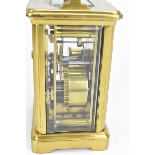 493 - A French brass and bevelled glass cased alarm clock, with white enamel face with Roman numerals, abo... 