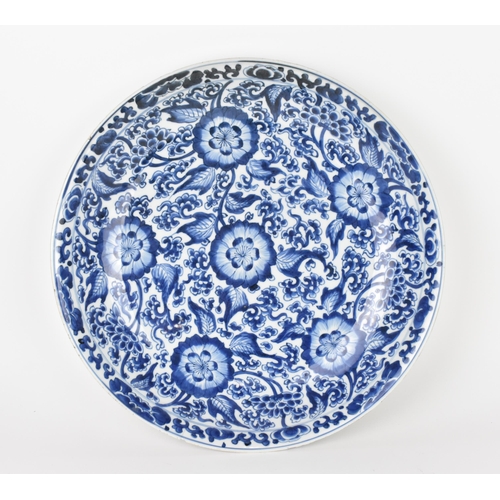 72 - A Chinese Qing dynasty blue and white porcelain charger, 19th century, of circular form with large b... 