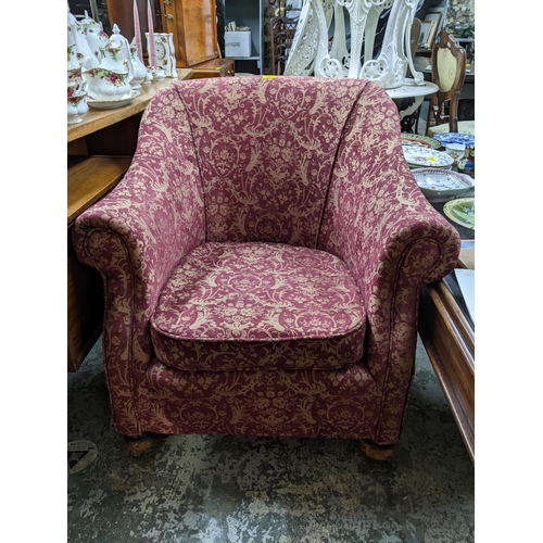 301 - A Victorian upholstered tub style armchair, bun turned front legs, on castors, the red fabric with a... 