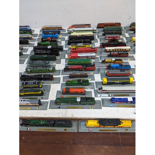 302 - A large collection of Del Prado model trains, partially held within a metal case Location: FSR