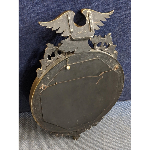 315 - A Regency style convex wall hanging mirror having an eagle surmount, the inner edge with applied sph... 