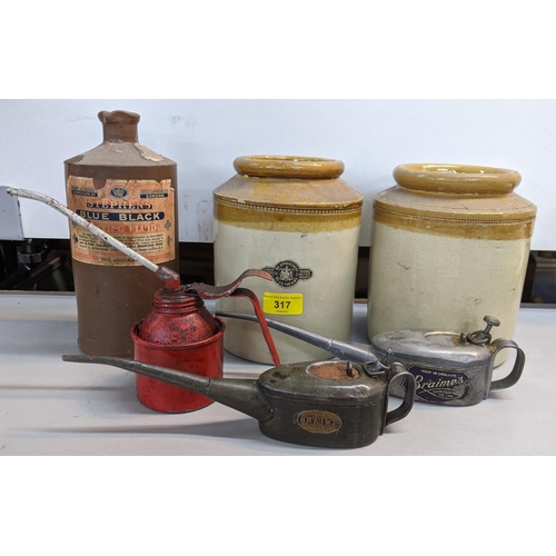 317 - Motoring memorabilia to include three oil cans, one unbranded and two branded Braimes/Braime, a Wait... 