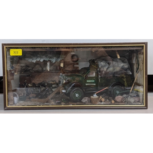 322 - A model garage scene in a glazed case depicting a Norton truck surrounded by tools and equipment in ... 