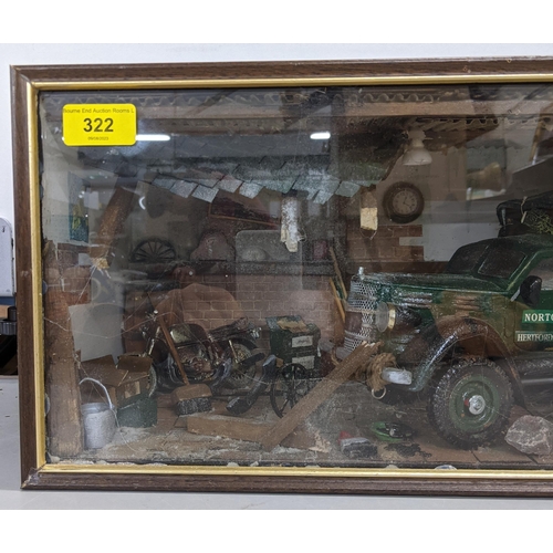 322 - A model garage scene in a glazed case depicting a Norton truck surrounded by tools and equipment in ... 