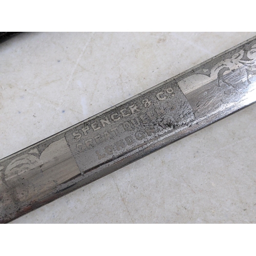 323 - A Masonic sword, the etched blade named for Spencer & Co Great Queen Street London WC, in a leather ... 