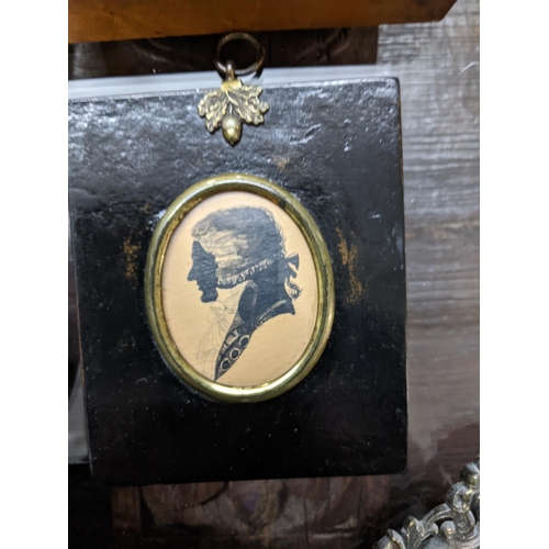 373 - A group of three framed Victorian pot lids, a silhouette portrait of a gentleman, reverse painted pi... 